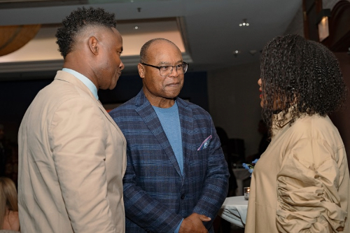 MMike Singletary, keynote speaker and former Chicago Bears' player, chats with retired NFL player Ray McElroy and his wife, Michelle
